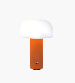 Mushroom-shaped table lamp with an orange base and white dome shade.