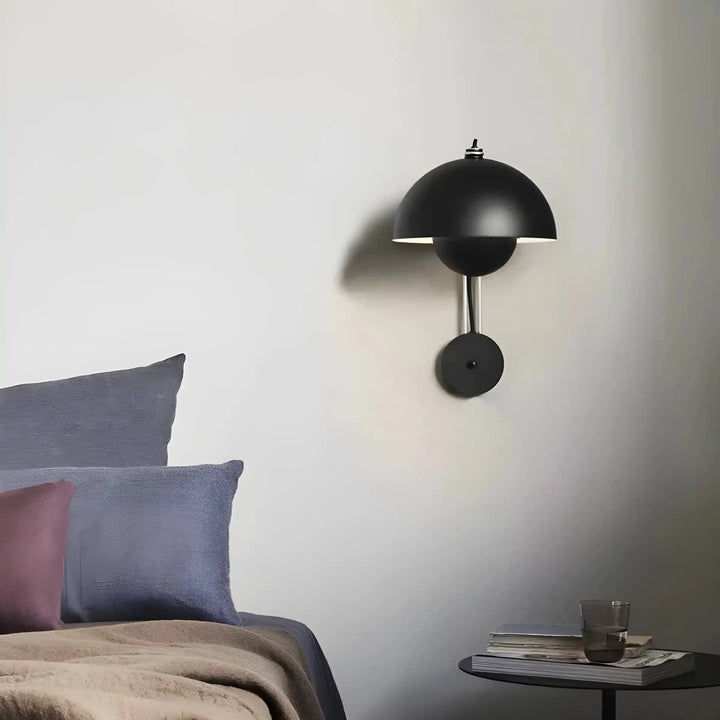 Black dome-shaped wall sconce with a thin horizontal light opening.