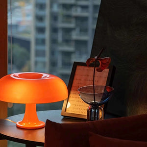 Bright orange mushroom-shaped table lamp with a rounded top.