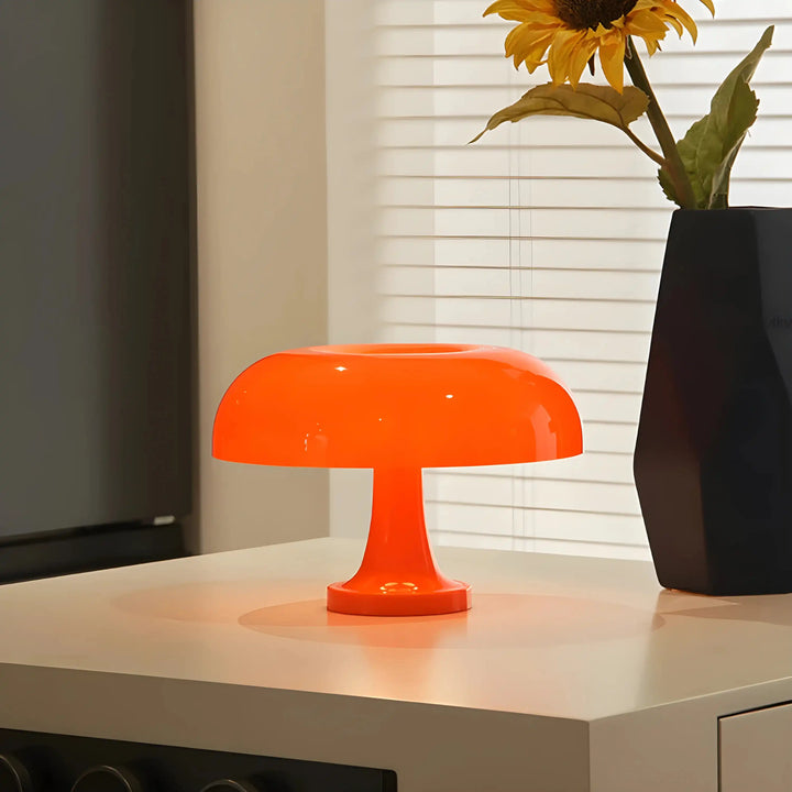 Bright orange mushroom-shaped table lamp.