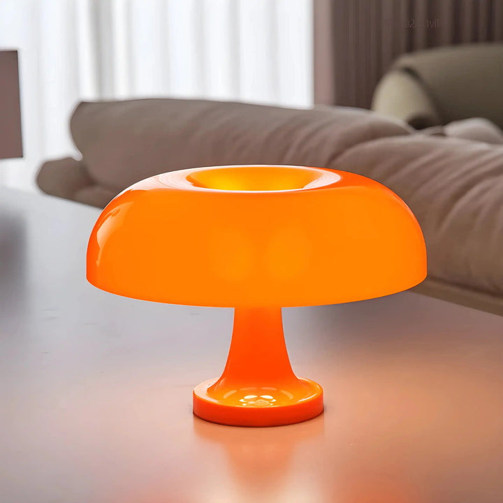 Bright orange mushroom-shaped table lamp with a rounded shade.