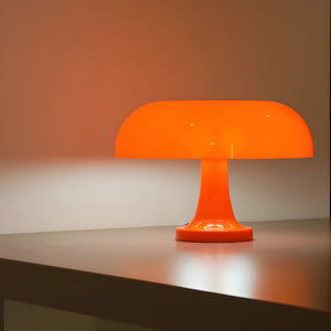 Bright orange mushroom-shaped table lamp with a rounded dome shade.