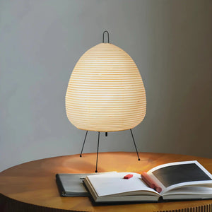 Egg-shaped paper lantern lamp with thin metal legs.