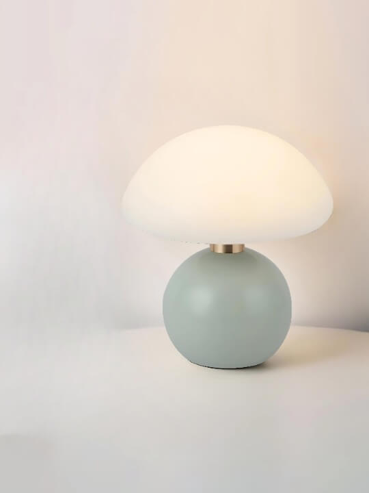 Mushroom-shaped table lamp with a pale green spherical base and white dome shade.