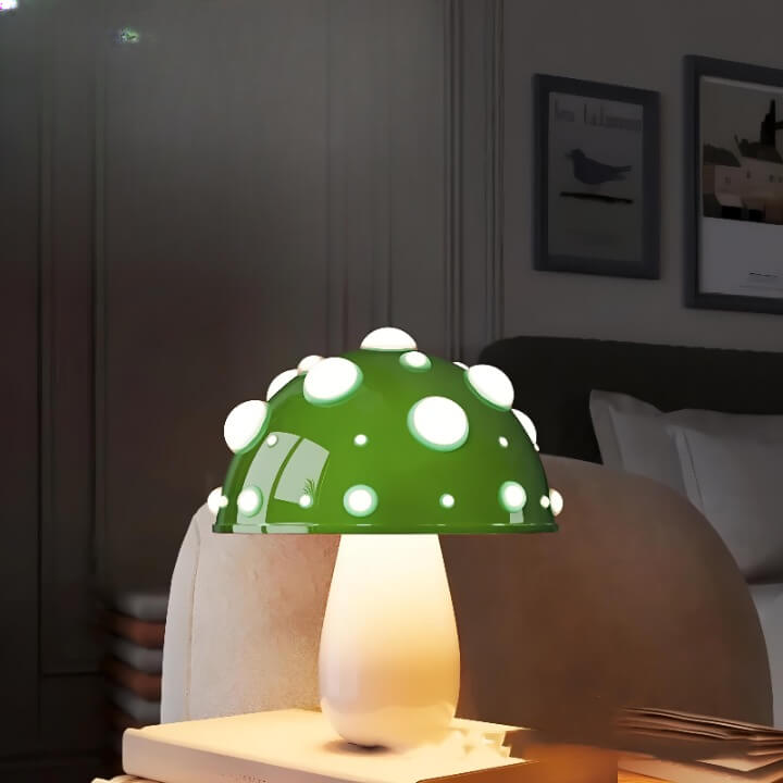 Whimsical mushroom-shaped table lamp with a green cap dotted with white spots.