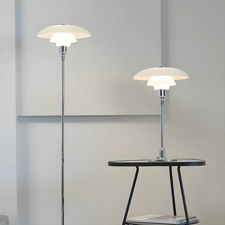 Modern floor and table lamps with tiered, saucer-shaped white shades.