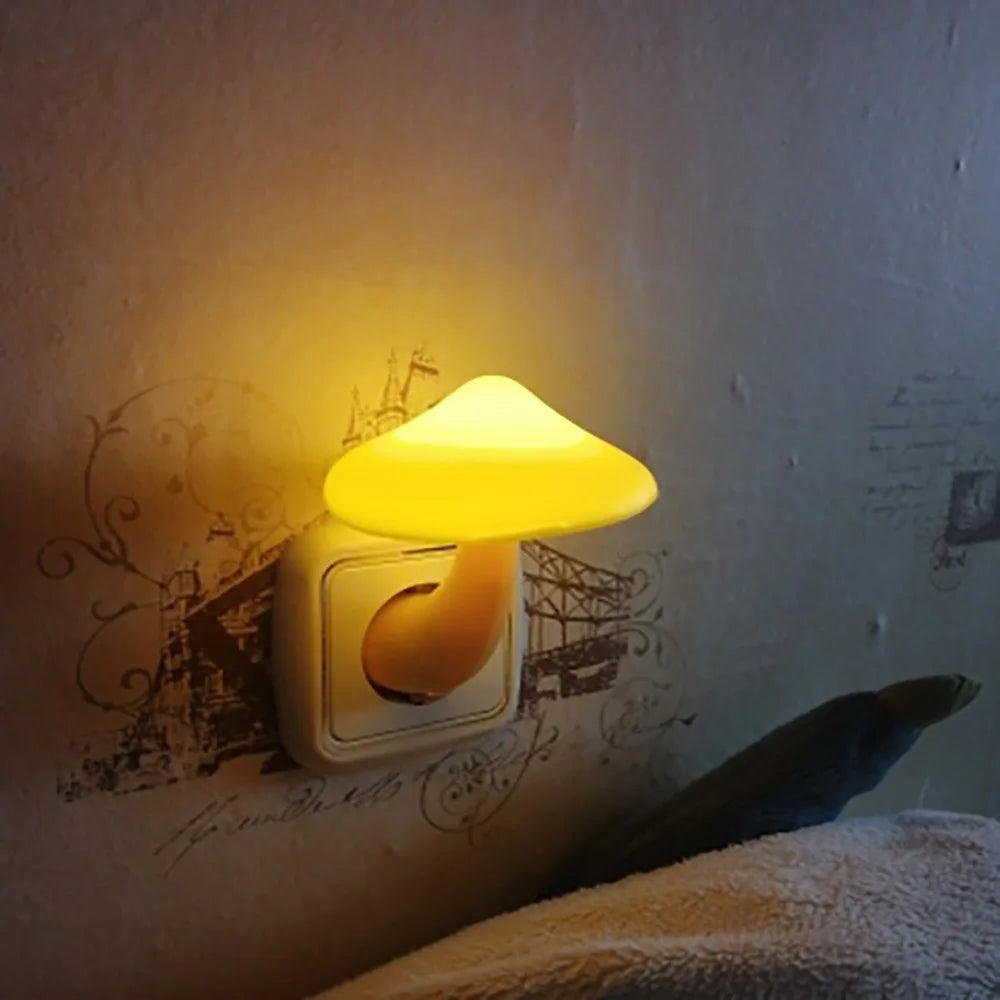 Glowing mushroom-shaped night light plugged into a wall socket.