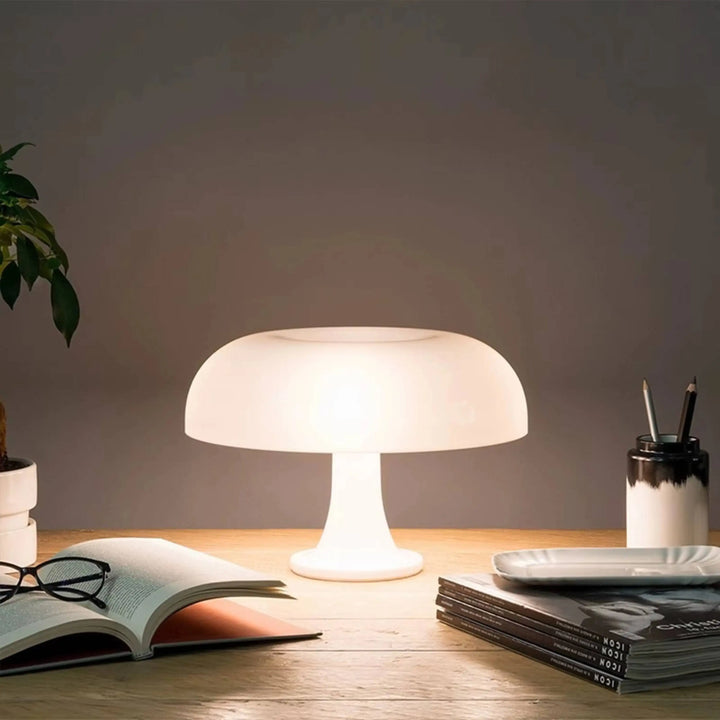 Glowing mushroom-shaped table lamp with a white dome shade.