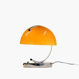 Orange dome-shaped table lamp with a curved metal base.