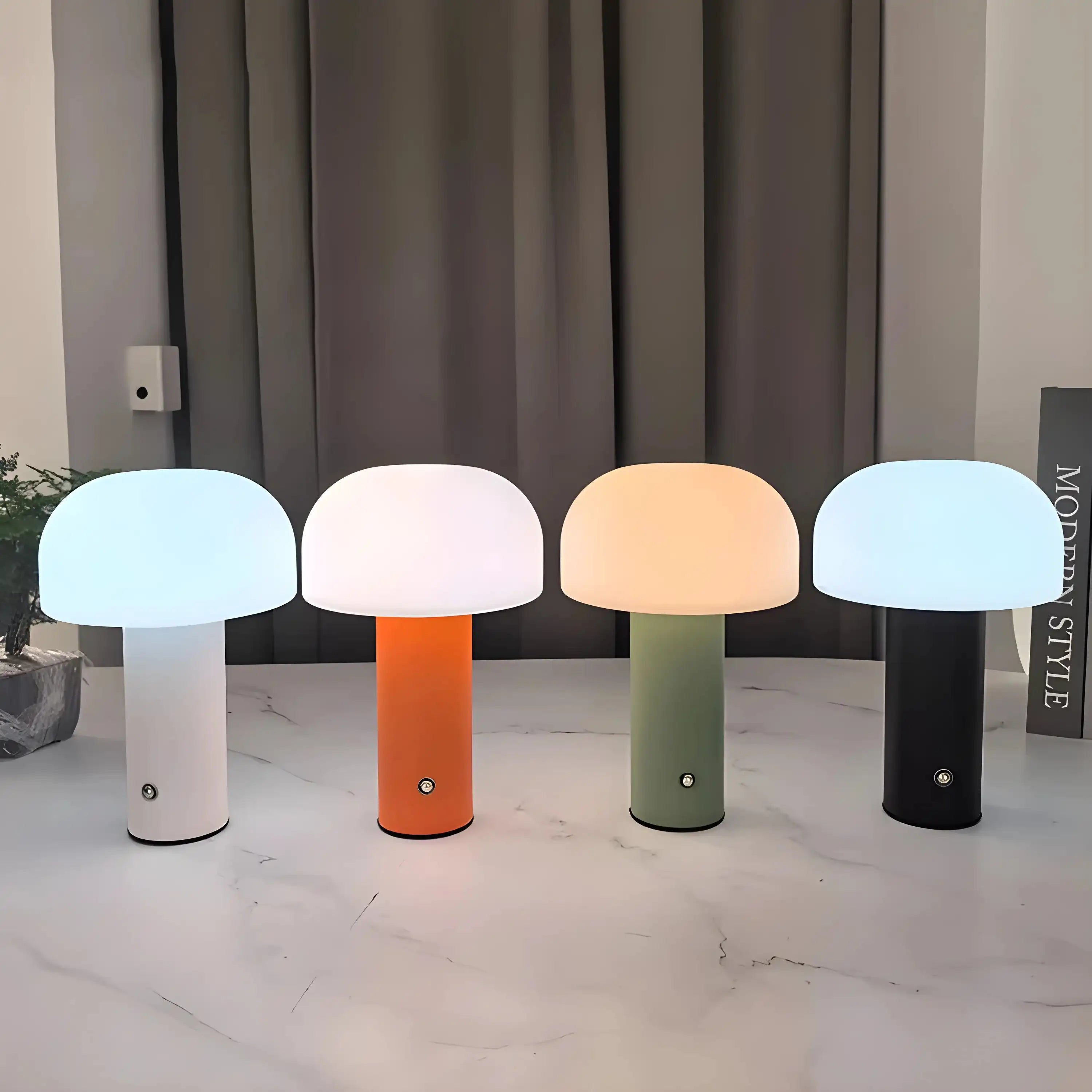 Set of four colorful mushroom-shaped table lamps with glowing domed tops.