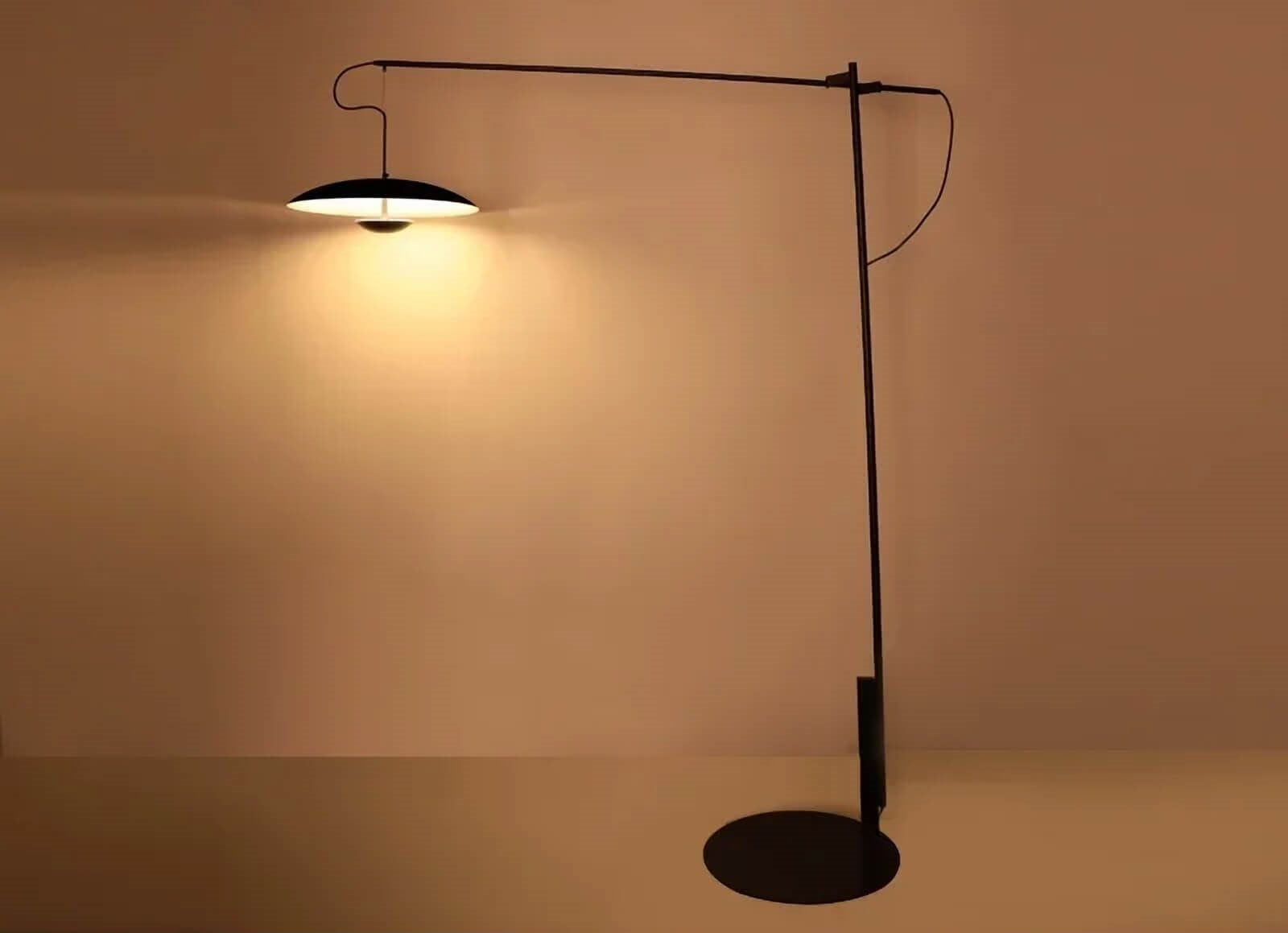 Sleek, modern desk lamp with a thin arm and flat circular shade.