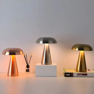 Trio of modern mushroom-shaped table lamps with metallic finishes.