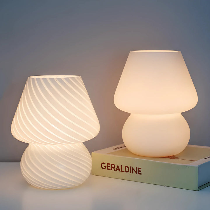 Two illuminated white table lamps with rounded, textured shades.