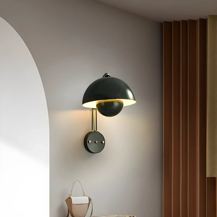 Wall-mounted lamp with a dark dome shade and gold interior.