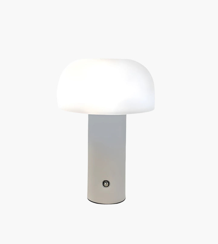 Modern table lamp with a white mushroom-shaped shade atop a cylindrical base.