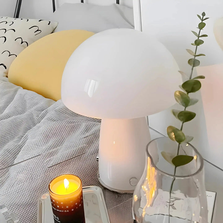 Mushroom-shaped table lamp with a white dome top and base.