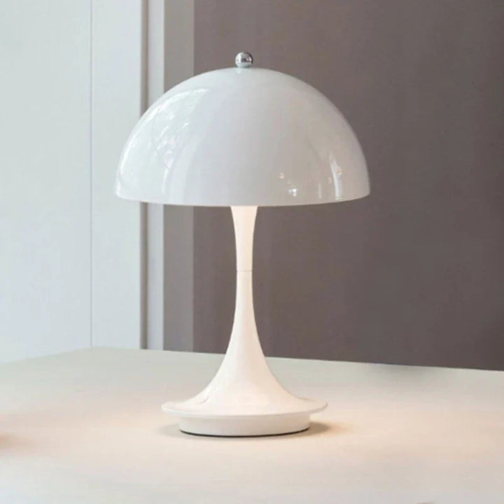 White mushroom-shaped table lamp with a domed shade.