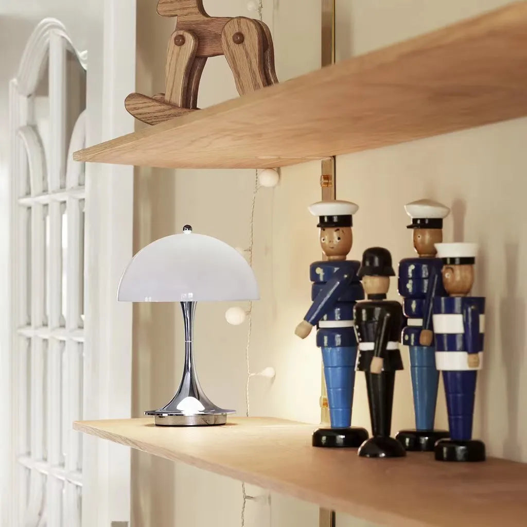 Wooden shelves displaying decorative sailor figurines and a small table lamp.