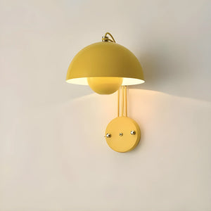 Yellow dome-shaped wall sconce with a circular base.